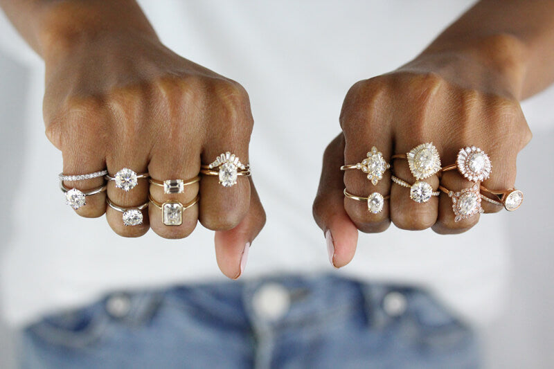 model wearing a variety of ethical engagement rings on each hand