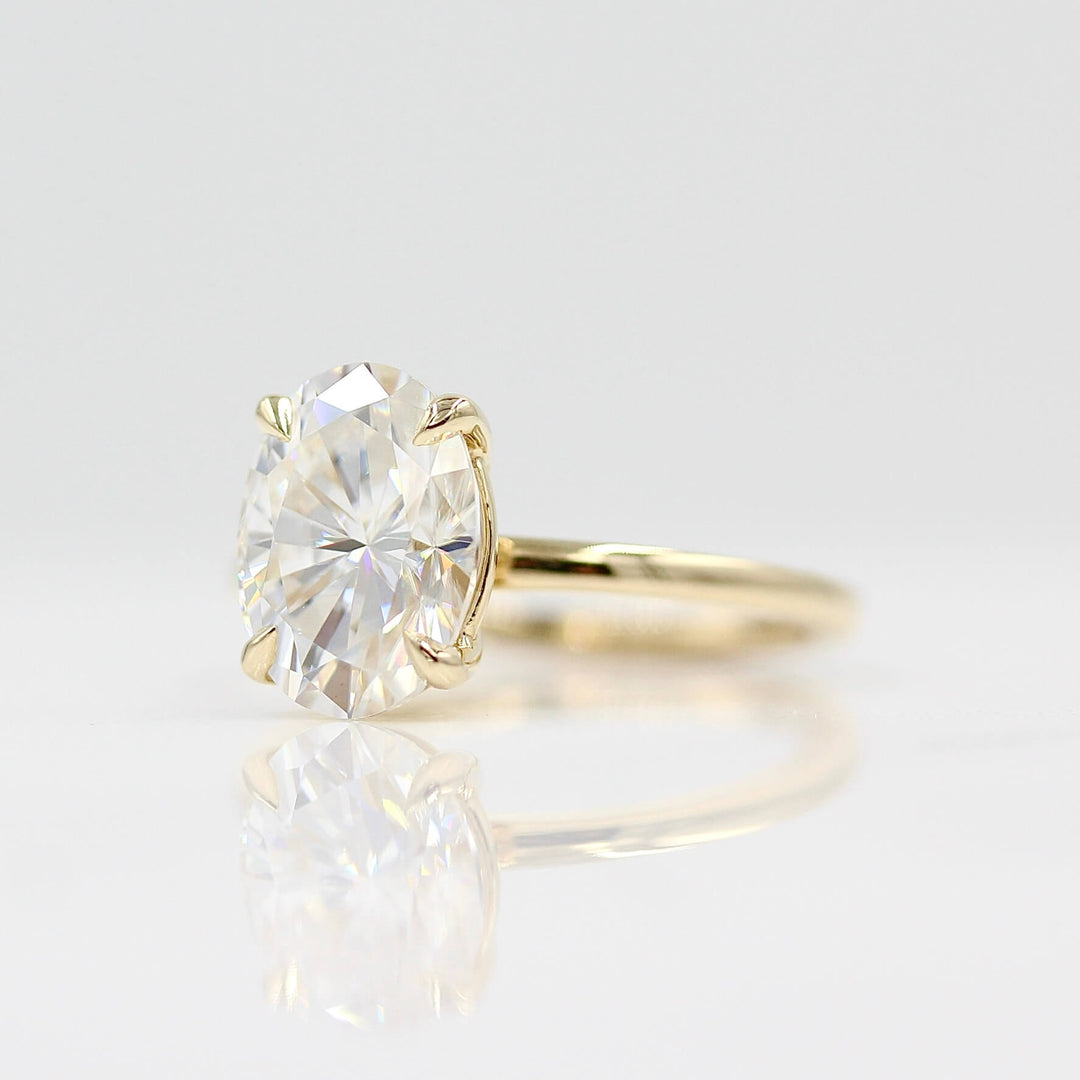 The Celeste Ring in Yellow Gold and Moissanite against a white background