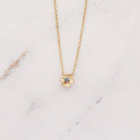The June Birthstone Poppy Necklace with Alexandrite in Yellow Gold against a white background