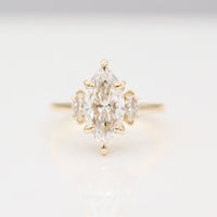 Yellow Gold Engagement Ring with a Marquise Diamond Center stone and Marquise Diamond side stones.