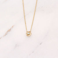 The March Birthstone Poppy Necklace with Aqua Spinel in Yellow Gold against a white background