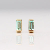 The August Baguette Birthstone Earrings with Chrysoberyl in Yellow Gold against a white background