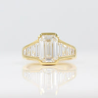 The Daphne Ring with a 3ct Emerald Lab-Grown Diamond in 18k Yellow Gold against a white background