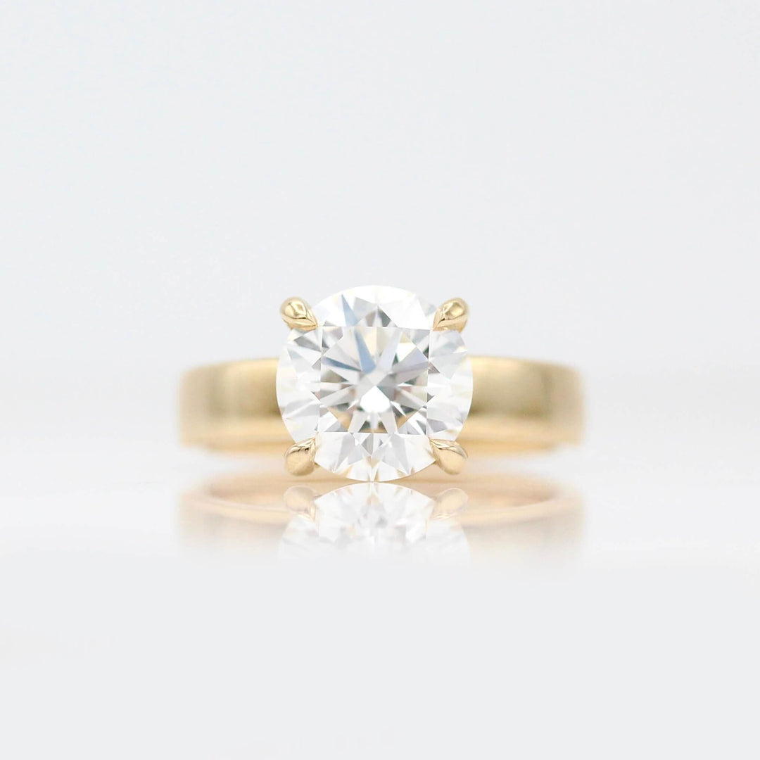 The Marilyn Ring (Round) in Yellow Gold with 3ct Lab-Grown Diamond against a white background