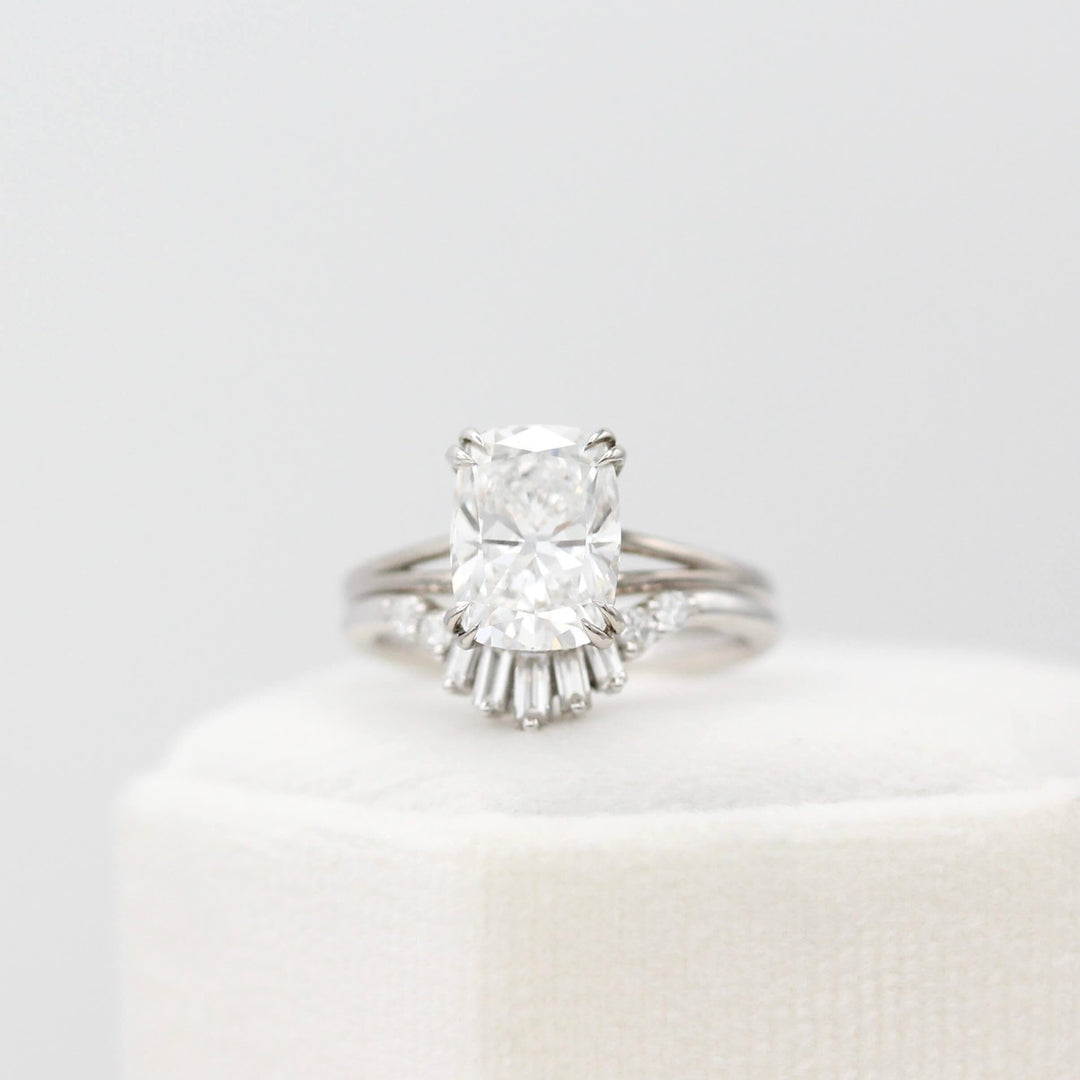 The Sunburst Wedding Band in White Gold stacked with the Sage Ring in White Gold with a 3ct Elongated Cushion Lab-Grown Diamond atop of a white velvet ring box