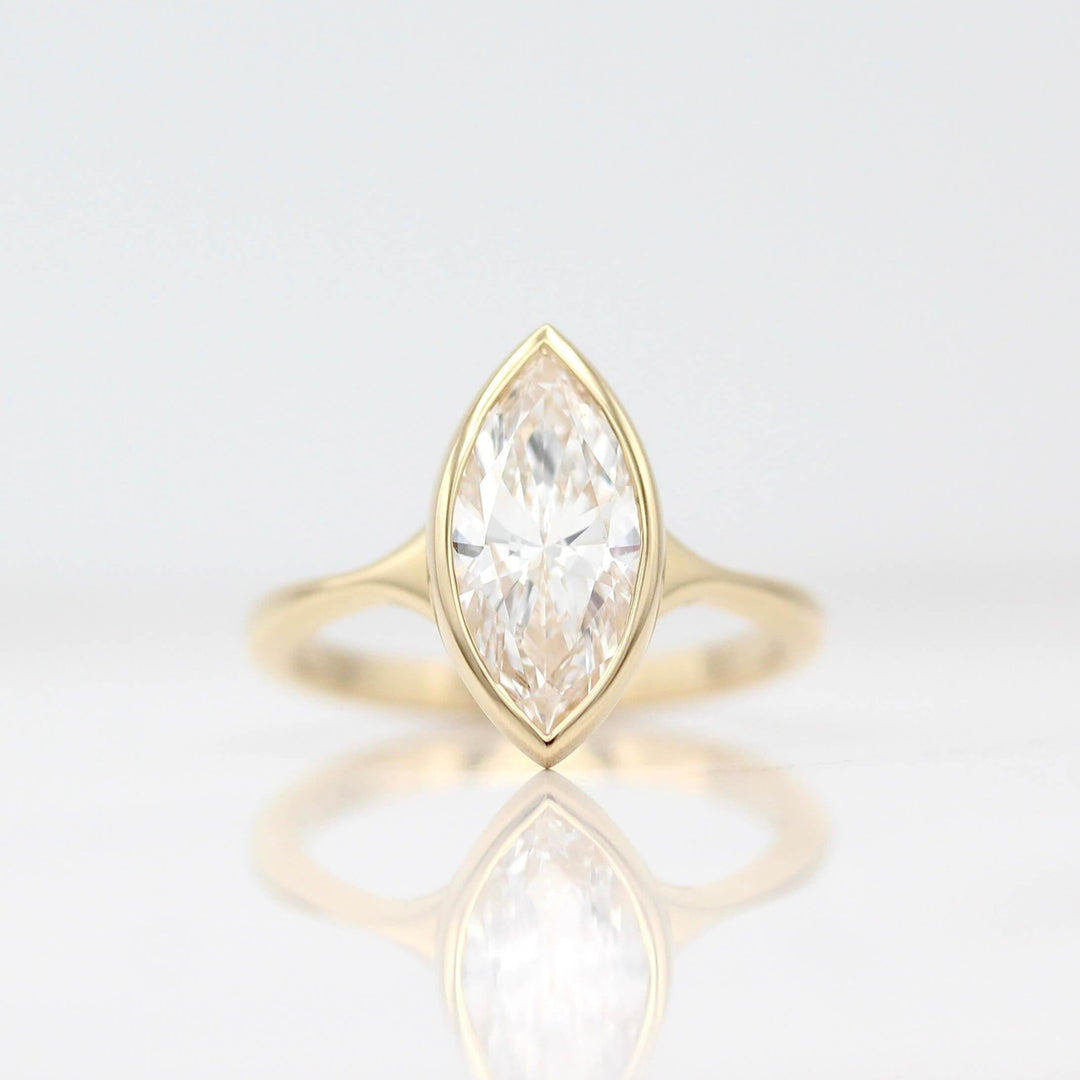 The Stevie Ring (Marquise) in Yellow Gold with a 2ct Lab-Grown Diamond against a white background
