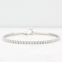 Diamond tennis bracelet in white gold on a white background