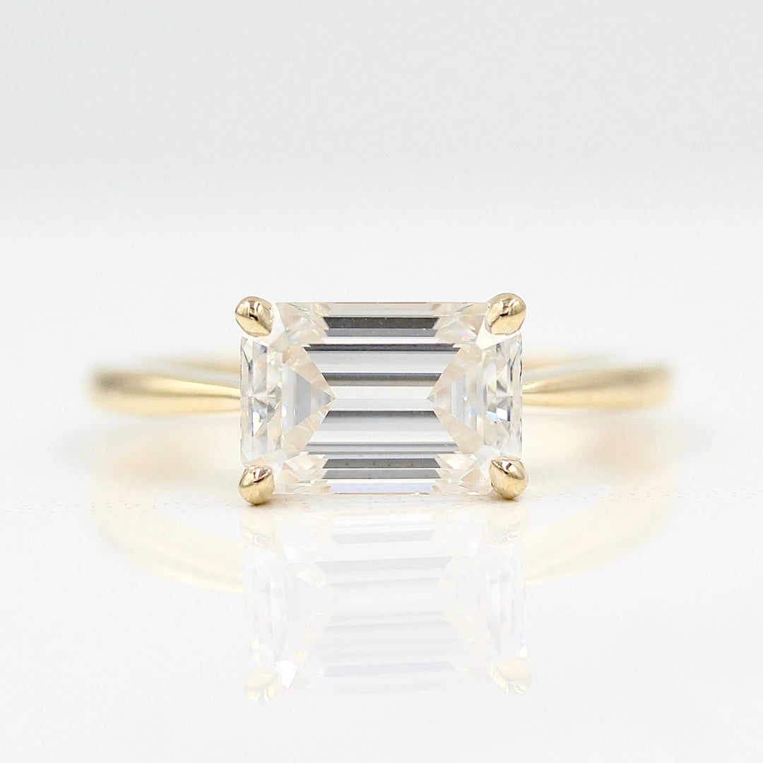 The Twyla ring emerald in yellow gold against a white background