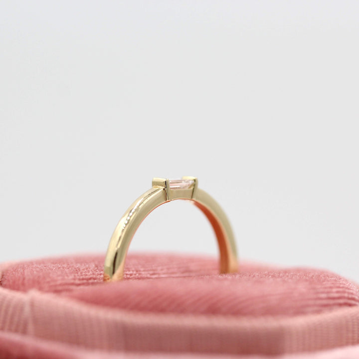 a gold baguette wedding ring in a ring box