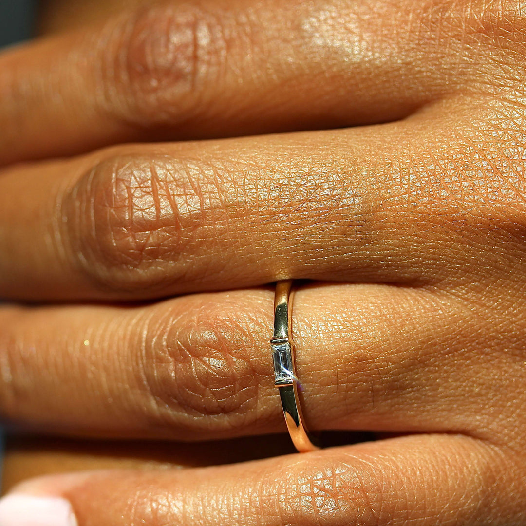 a model wearing a gold baguette ring