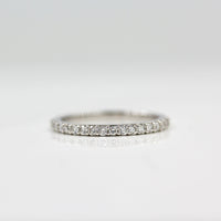 a silver pavé wedding band on white surface