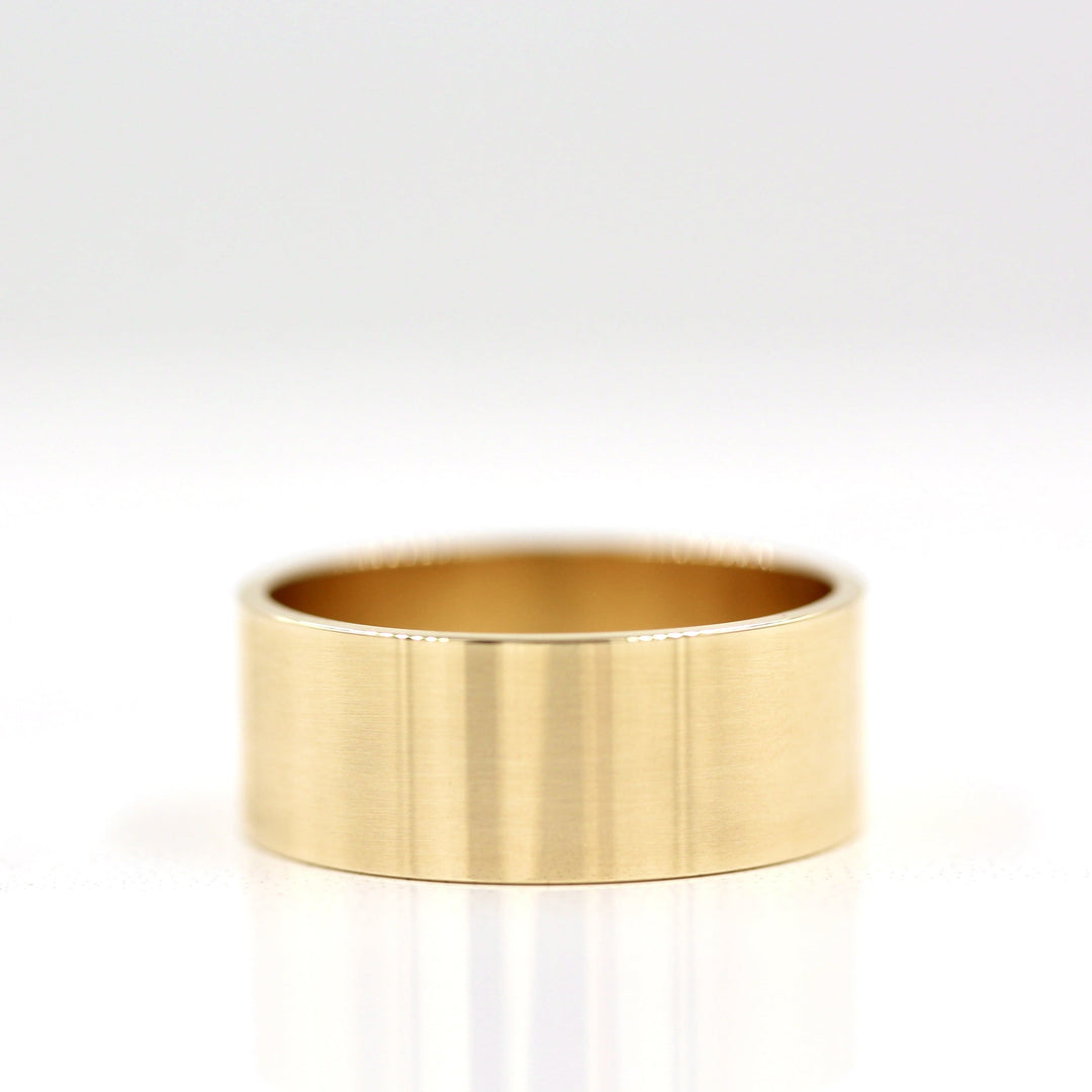 The 8mm Cigar Band in Yellow Gold against a white background