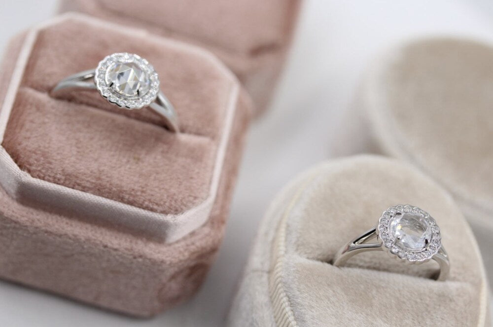 engagement rings in pink and white ring boxes