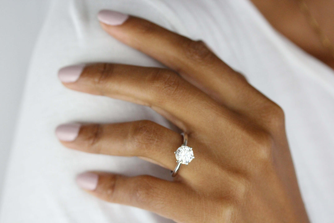 woman wearing a mine-free solitaire diamond engagement ring