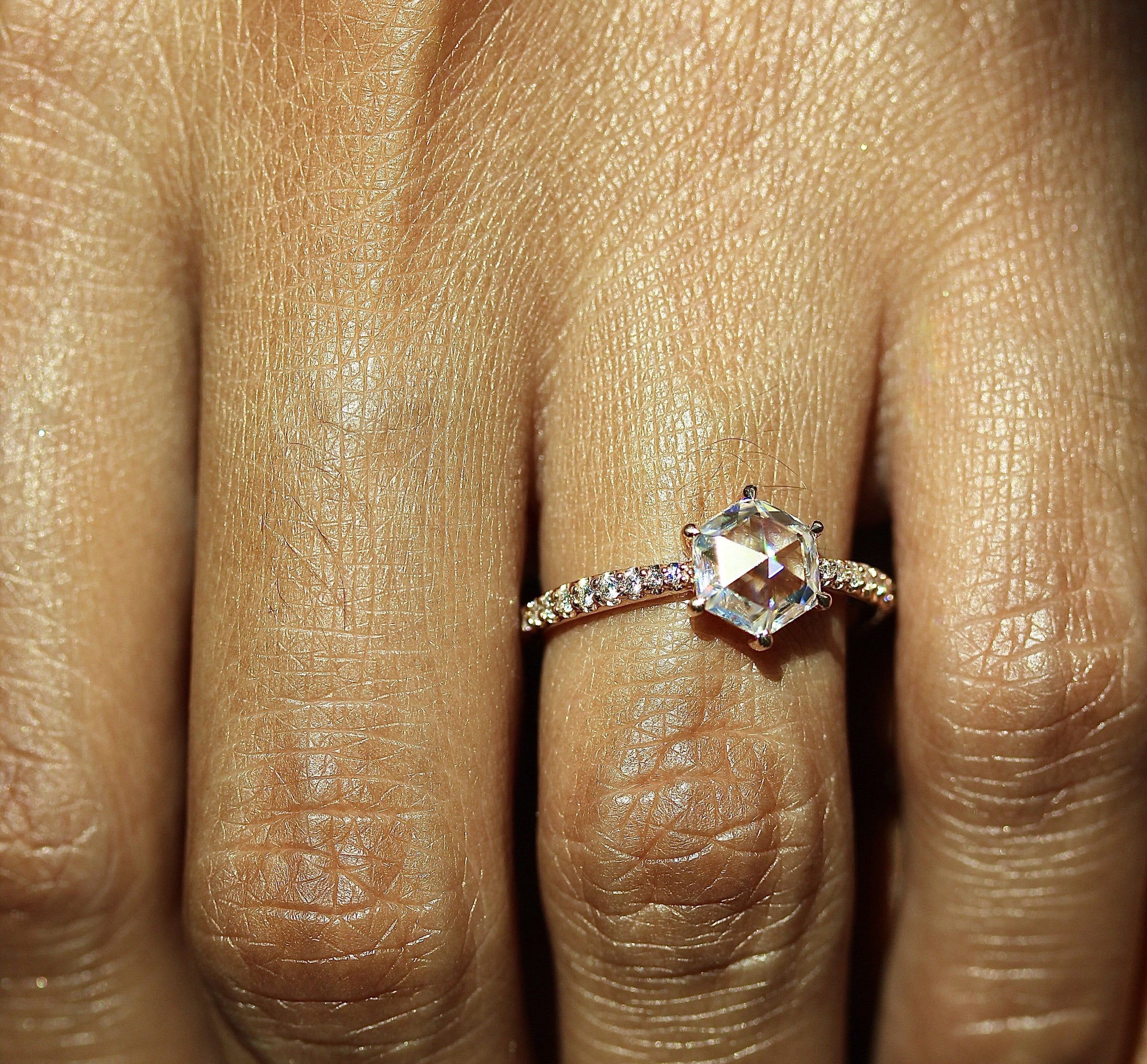 The Nora Ring (Hexagon) in Rose Gold modeled on a hand