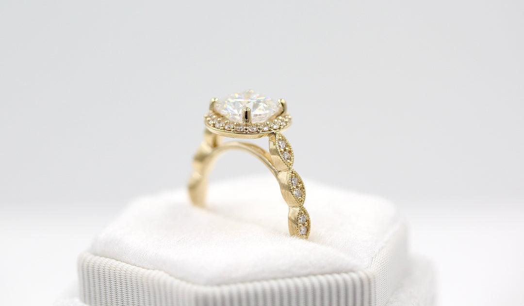 The Isla Ring in yellow gold in a white velvet ring box