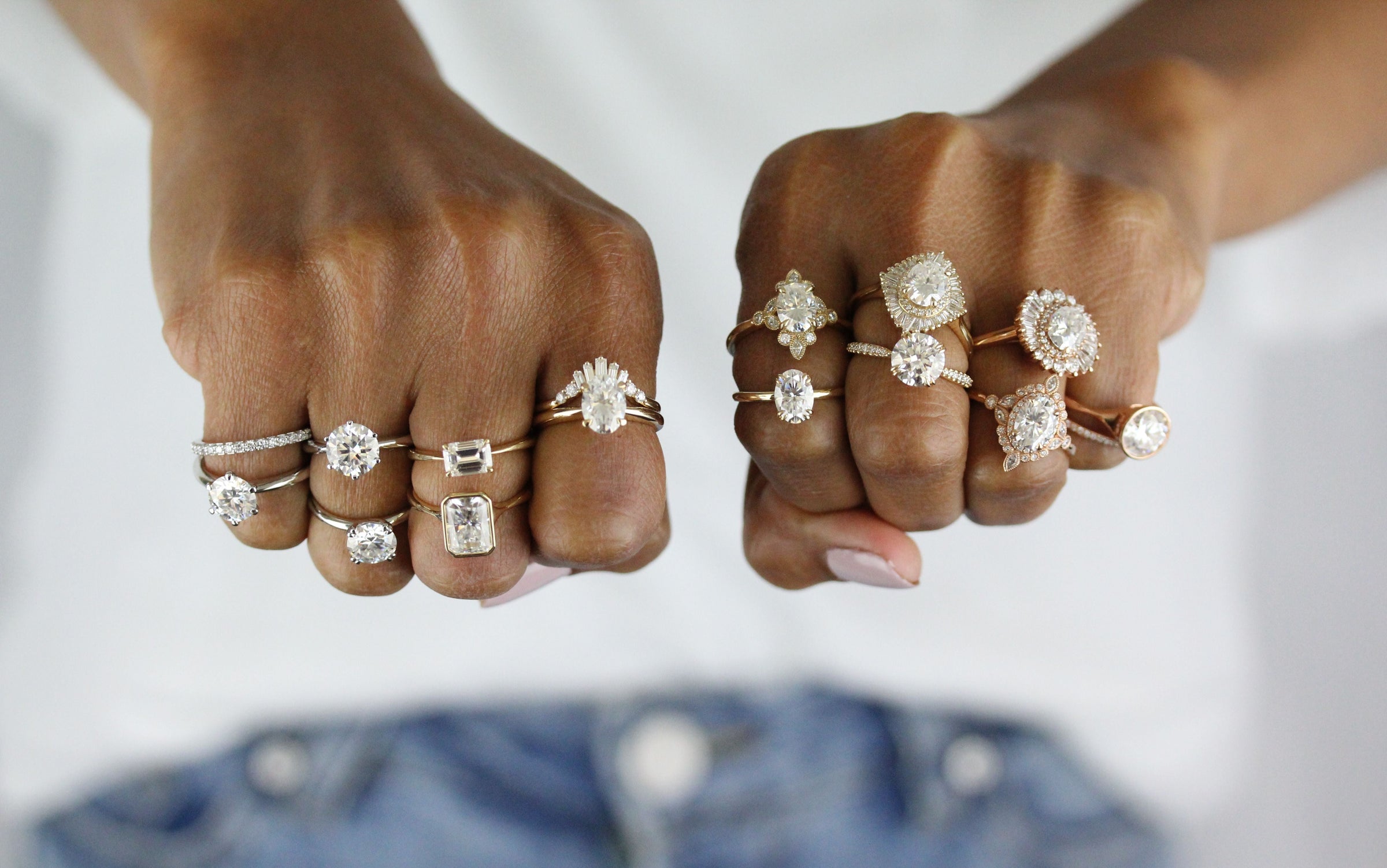 Sixteen rings stacked on a pair of knuckles