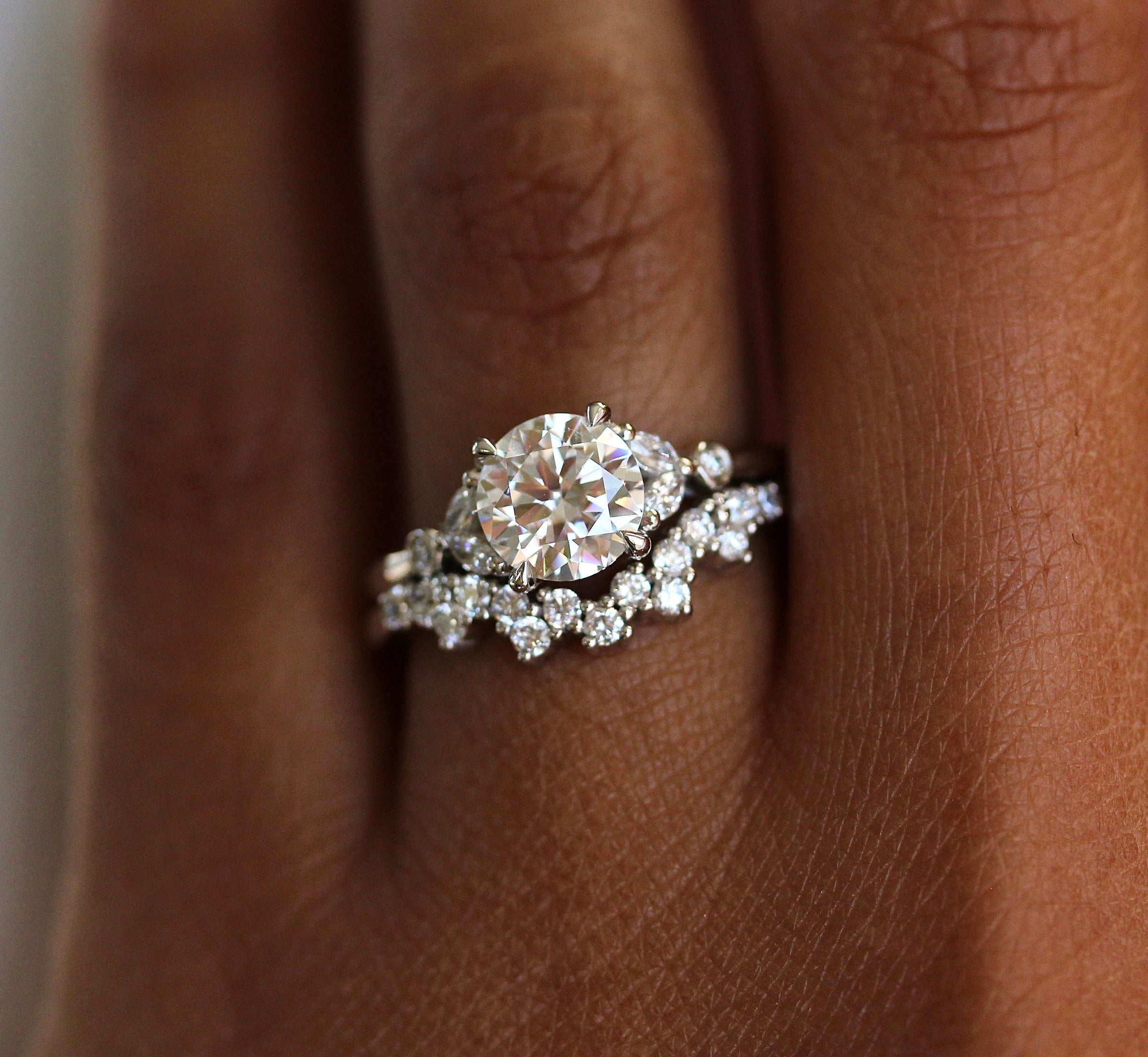 The Sophia Ring (Round) in white gold stacked with the Nova wedding band in white gold modeled on a hand