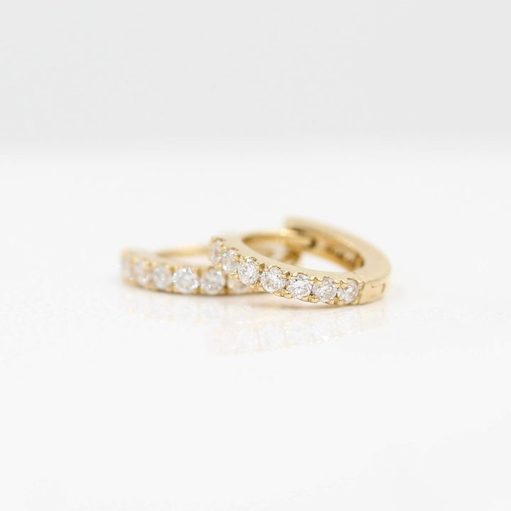 10mm Diamond Huggies in Yellow Gold against a white background