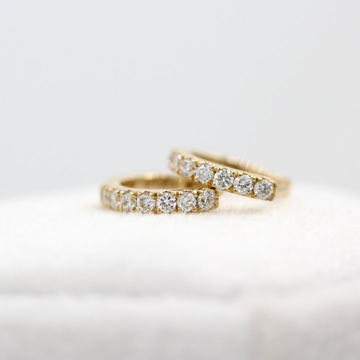 10mm Diamond Huggies in Yellow Gold atop a white velvet ring box