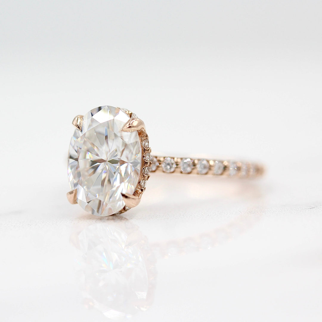 The Athena Hidden Halo Ring (Oval) in Rose Gold and Moissanite against a white background