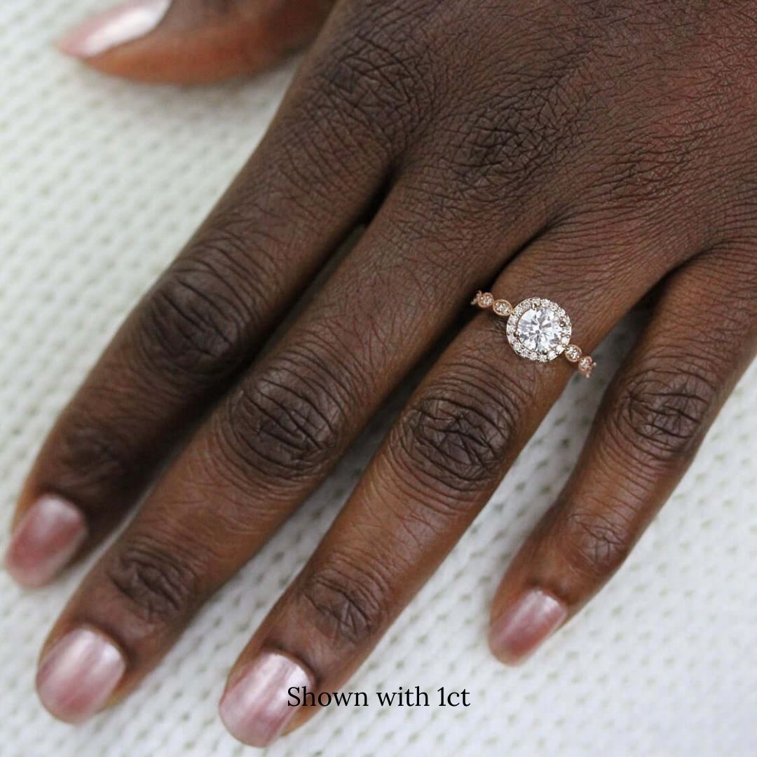 The Isla Ring (Round) in rose gold modeled on a hand with a dark complexion