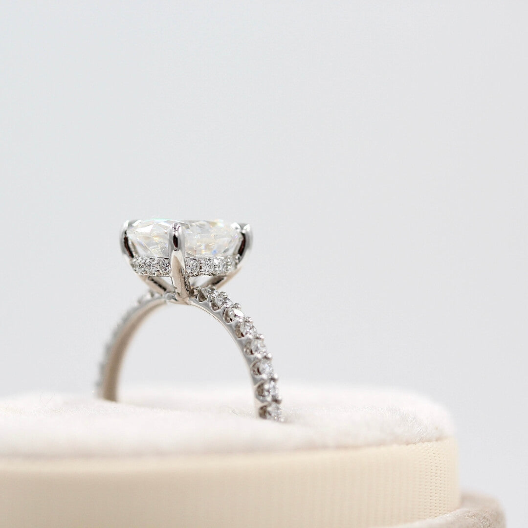 The Athena Hidden Halo Ring (Oval) in white gold in a white velvet ring box