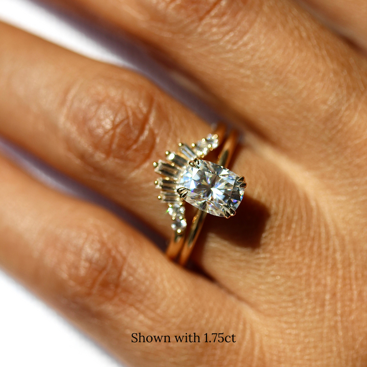 The Serena Ring (Elongated Cushion) with 1.75ct Moissanite in yellow gold stacked with the Sunburst wedding band in yellow gold modeled on a hand