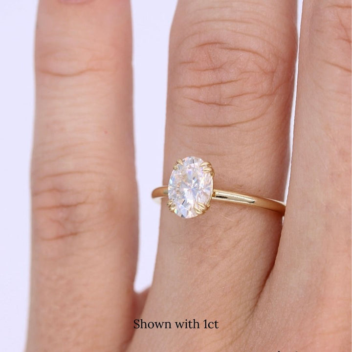 The Serena Ring (Oval) in yellow gold modeled on a hand with a light complexion