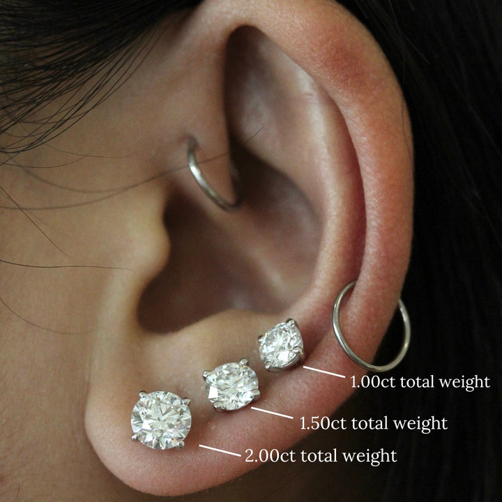 3 diamond studs on a tan ear