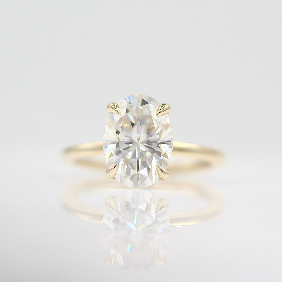 The Celeste Ring in Yellow Gold and Moissanite against a white background