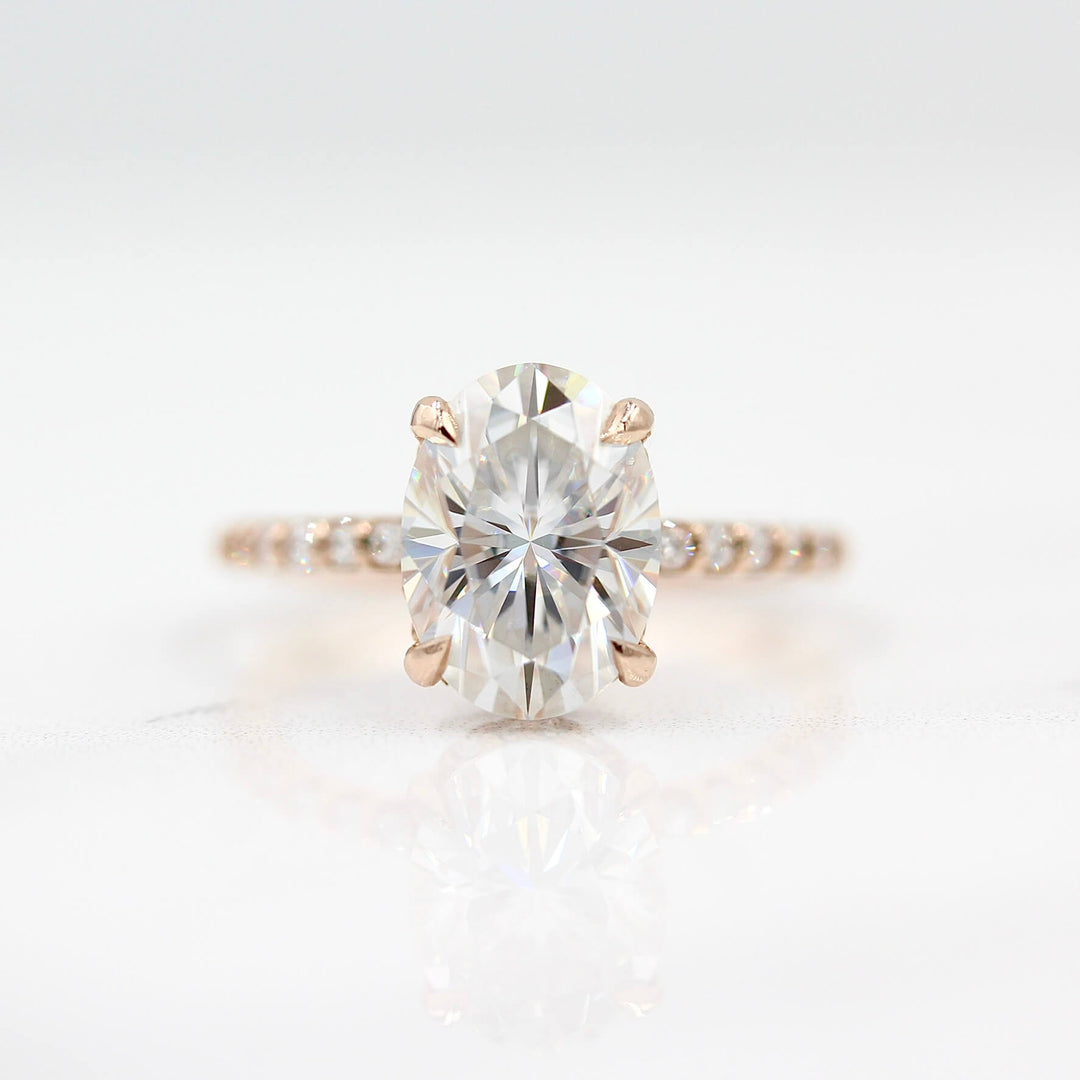 The Athena Hidden Halo Ring (Oval) in Rose Gold and Moissanite against a white background