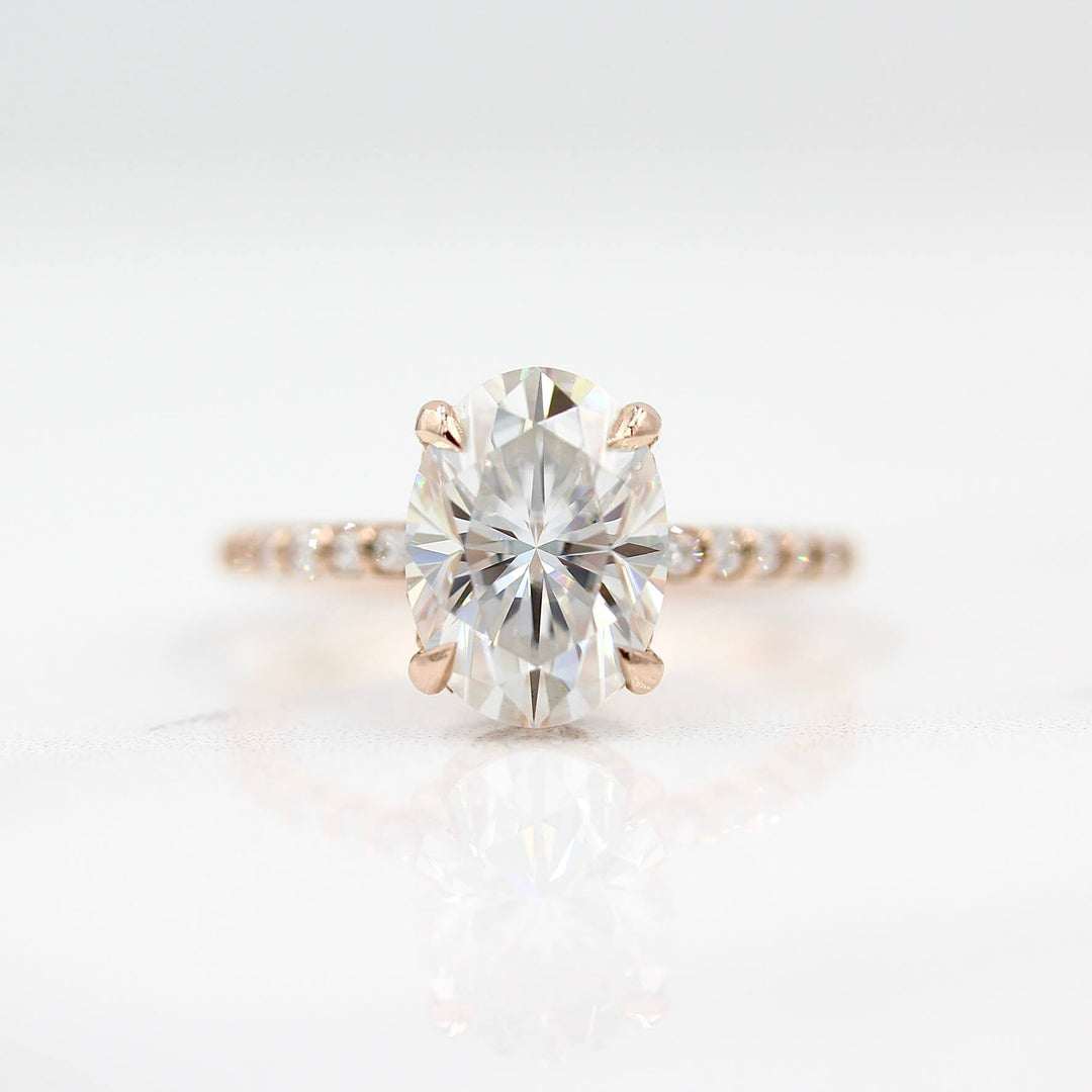 The Athena Hidden Halo Ring (Oval) in Rose Gold and Moissanite against a white background