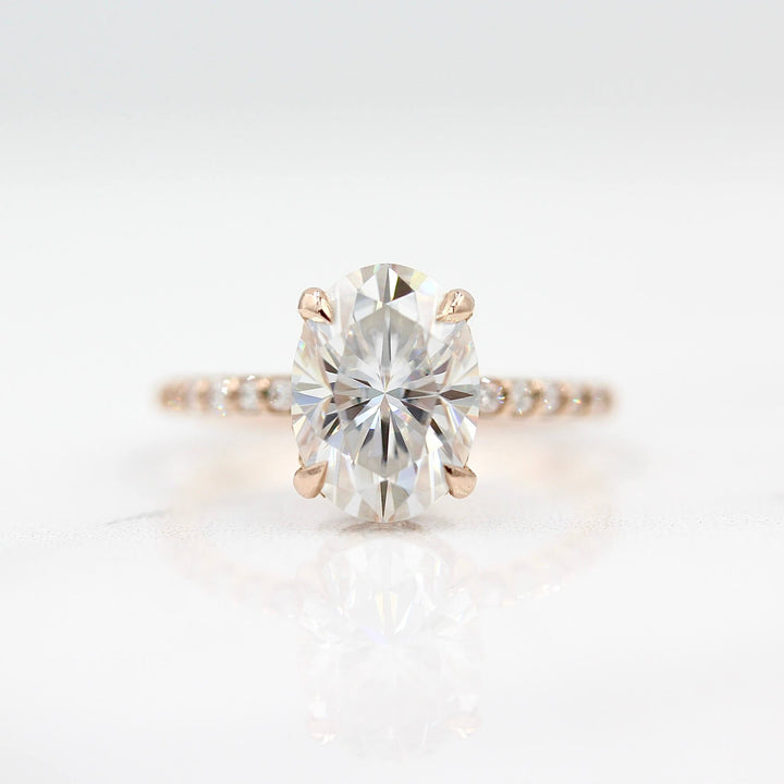 The Athena Hidden Halo Ring (Oval) in Rose Gold and Moissanite against a white background