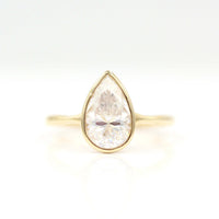 The Stevie Ring (Pear) in yellow gold against a white background