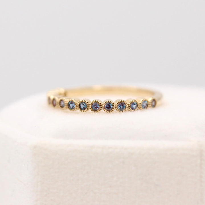 The June Florence Birthstone Wedding Band with Alexandrite in a white velvet ring box