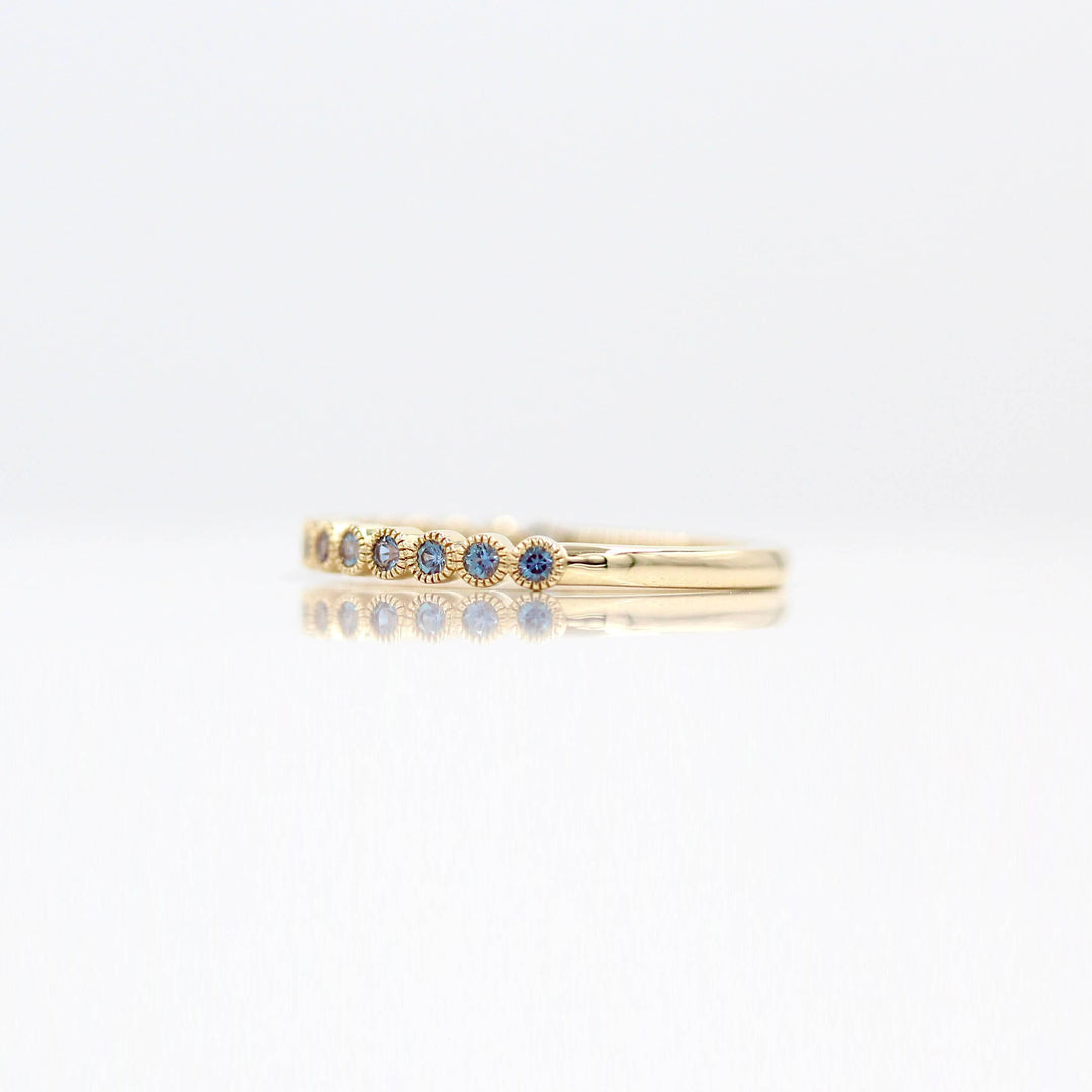 The June Florence Birthstone Wedding Band with Alexandrite against a white background