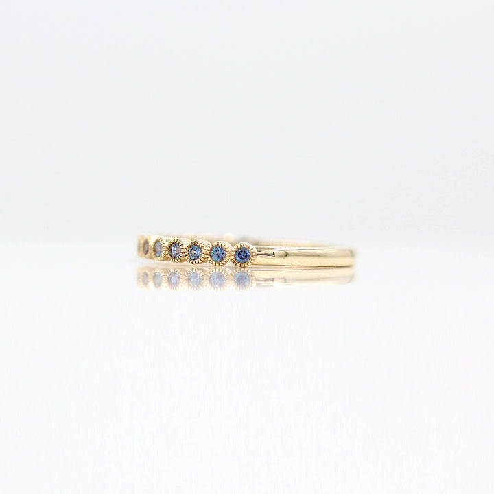 The June Florence Birthstone Wedding Band with Alexandrite against a white background