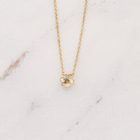 The June Birthstone Poppy Necklace with Alexandrite in Yellow Gold against a white background