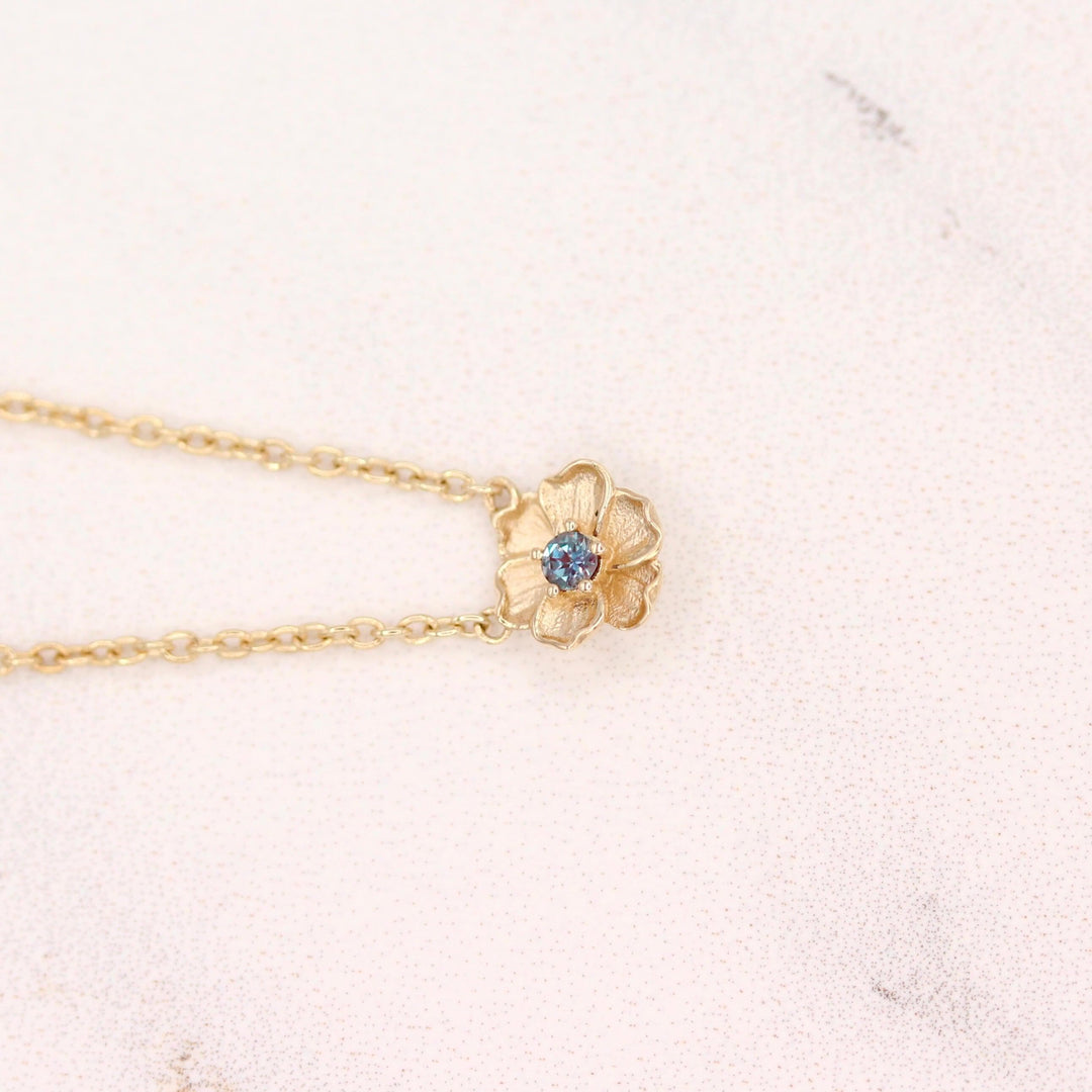 The June Birthstone Poppy Necklace with Alexandrite in Yellow Gold against a white background