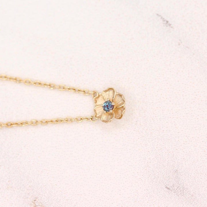 The June Birthstone Poppy Necklace with Alexandrite in Yellow Gold against a white background