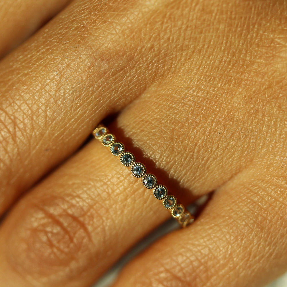 The March Florence Birthstone Wedding Band with Aqua Spinel in Yellow Gold modeled