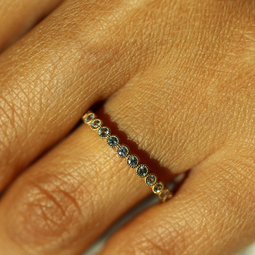 The March Florence Birthstone Wedding Band with Aqua Spinel in Yellow Gold modeled