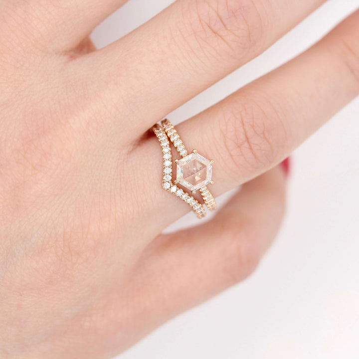 The Aurora Ring (Hexagon) in Rose Gold and 1ct Moissanite stacked with the Diamond V-Band in rose gold modeled on a hand