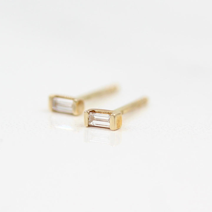 Baguette Earrings in Yellow Gold against a white background