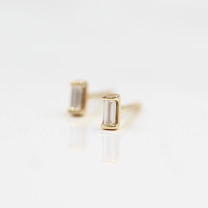 Baguette Earrings in Yellow Gold against a white background