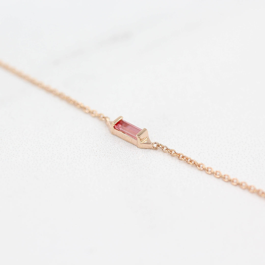 The Baguette Peachy-Pink Sapphire Necklace in Rose Gold against a white background