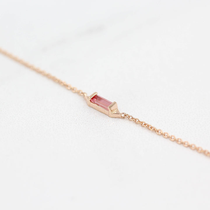 The Baguette Peachy-Pink Sapphire Necklace in Rose Gold against a white background