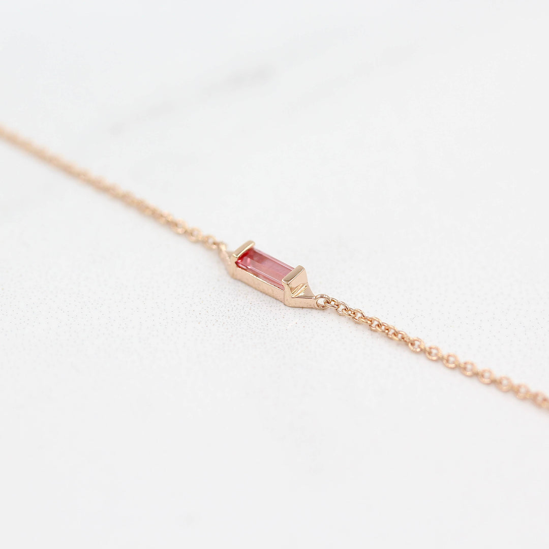 The Baguette Peachy-Pink Sapphire Necklace in Rose Gold against a white background