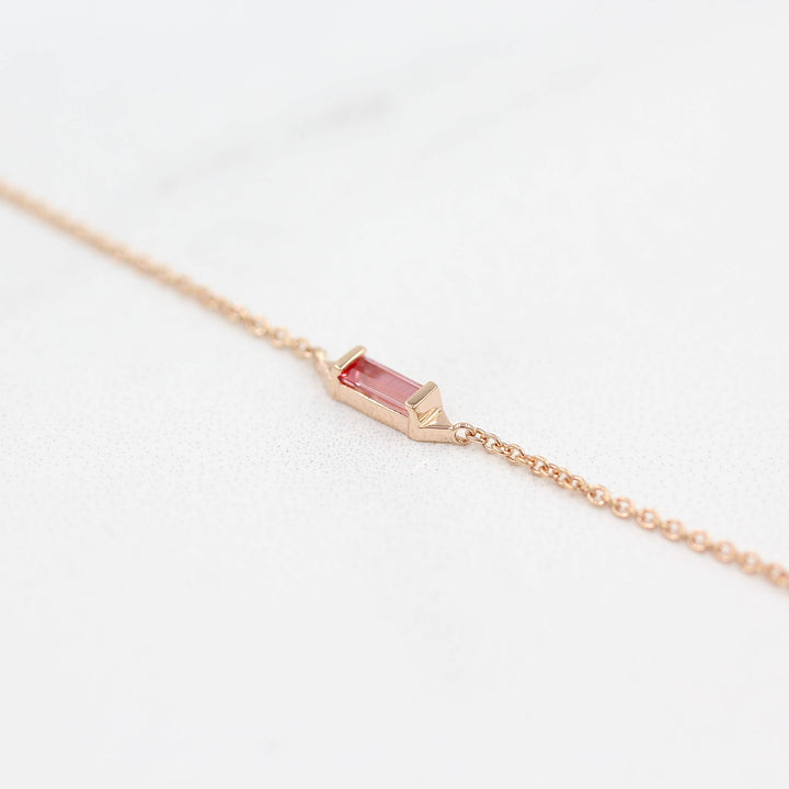 The Baguette Peachy-Pink Sapphire Necklace in Rose Gold against a white background